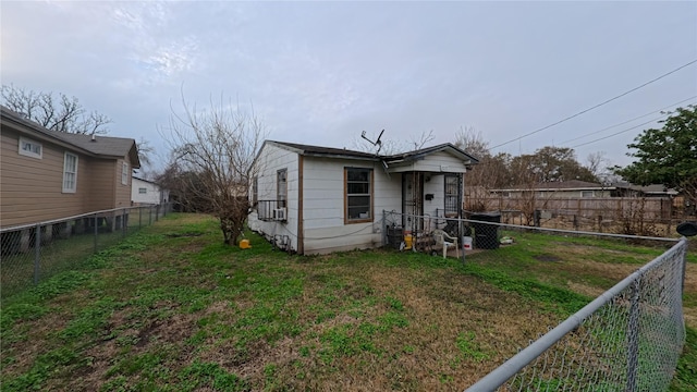 back of property featuring a lawn