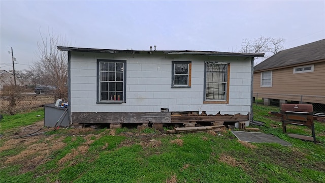 rear view of house featuring a lawn