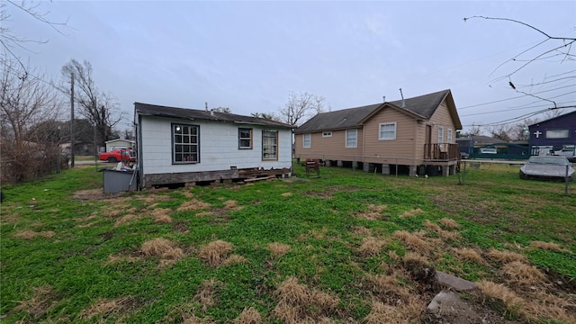 rear view of property featuring a lawn