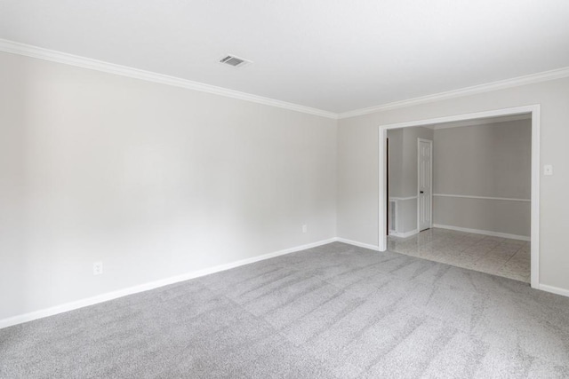 carpeted spare room with crown molding