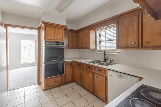 kitchen with double oven, light colored carpet, sink, and dishwasher