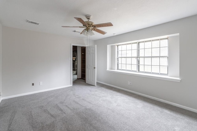 carpeted empty room with ceiling fan