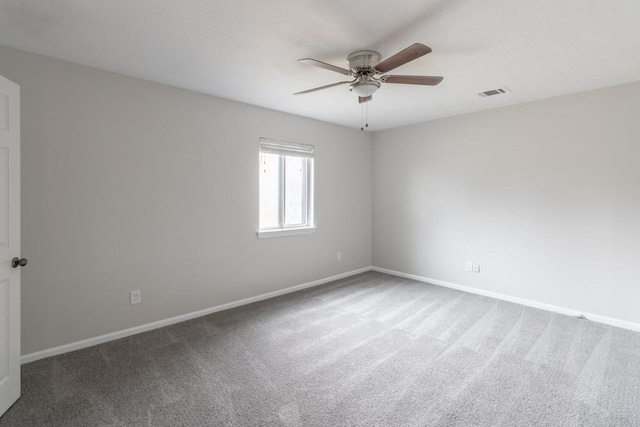 spare room featuring carpet floors and ceiling fan