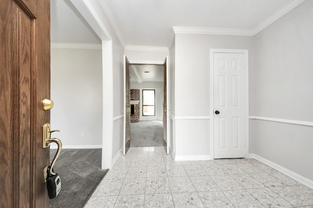 carpeted entryway featuring a fireplace and ornamental molding