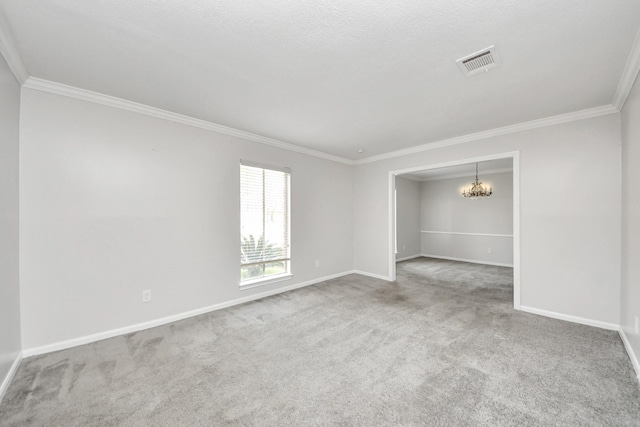 spare room featuring an inviting chandelier, carpet floors, and ornamental molding