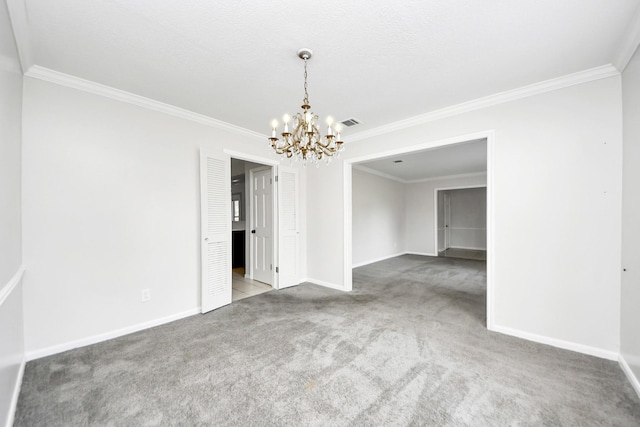 spare room with an inviting chandelier, carpet flooring, and crown molding