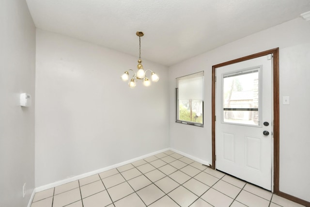 interior space featuring a notable chandelier and light tile patterned flooring