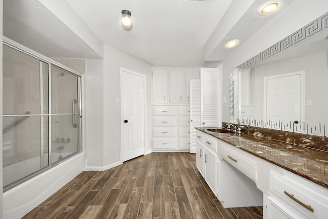 bathroom with vanity and bath / shower combo with glass door