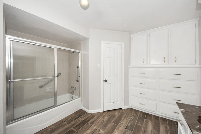 bathroom with vanity, wood-type flooring, and shower / bath combination with glass door