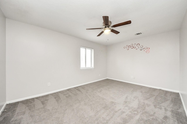 empty room with ceiling fan and carpet floors