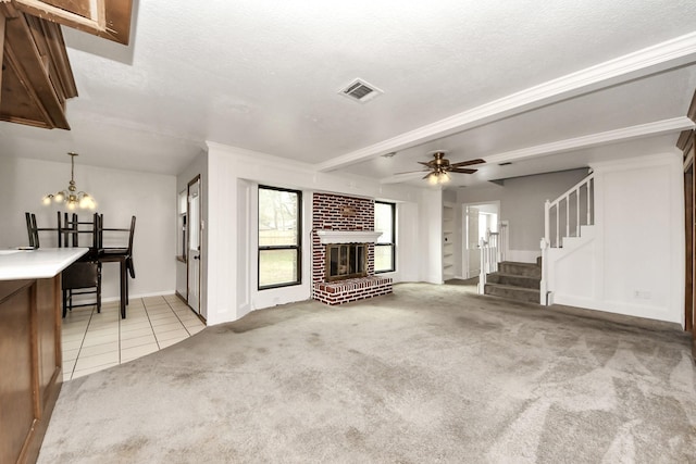 unfurnished living room featuring light colored carpet, a brick fireplace, a textured ceiling, ceiling fan, and beam ceiling