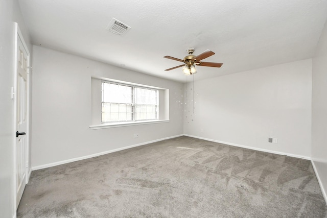 spare room with ceiling fan and carpet flooring