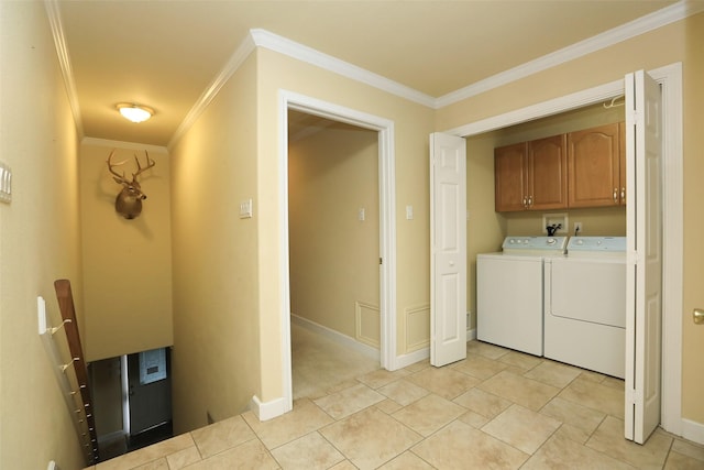 laundry area featuring crown molding, cabinets, light tile patterned floors, and washing machine and clothes dryer