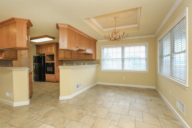 kitchen with decorative light fixtures, black appliances, a raised ceiling, crown molding, and an inviting chandelier