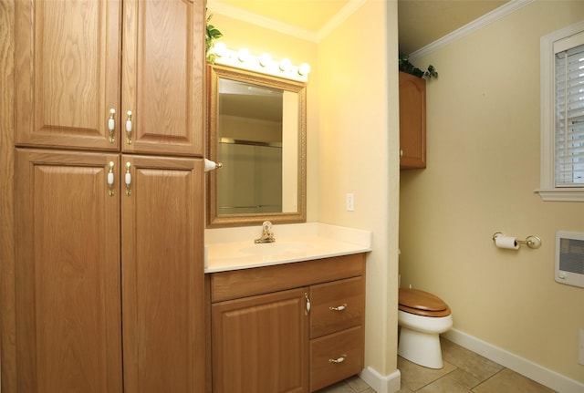 bathroom with heating unit, vanity, toilet, crown molding, and tile patterned floors