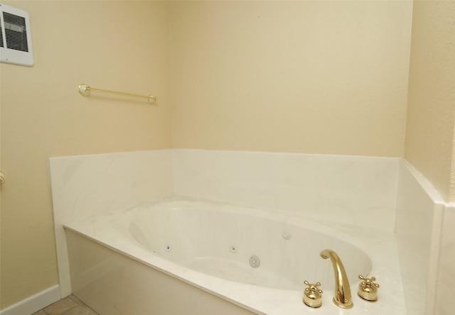 bathroom with tile patterned flooring and a washtub