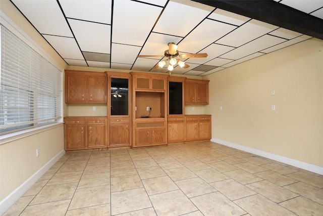 unfurnished living room with light tile patterned floors and ceiling fan