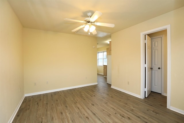 spare room with hardwood / wood-style floors and ceiling fan