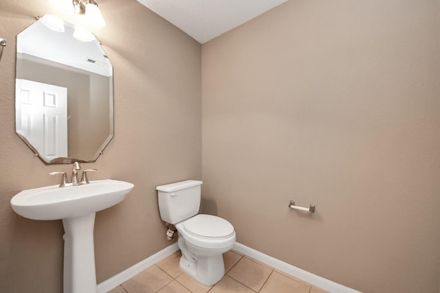 bathroom with tile patterned floors, toilet, and sink