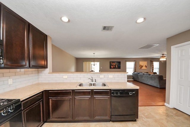 kitchen featuring sink, decorative backsplash, hanging light fixtures, black appliances, and dark brown cabinets