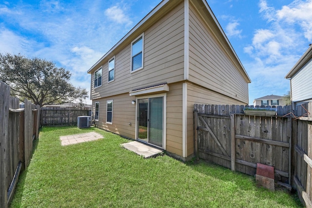 back of house featuring a patio, central air condition unit, and a lawn