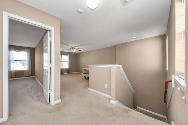 hallway featuring light carpet