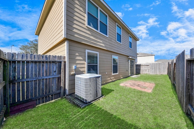 back of house featuring a patio, a yard, and cooling unit