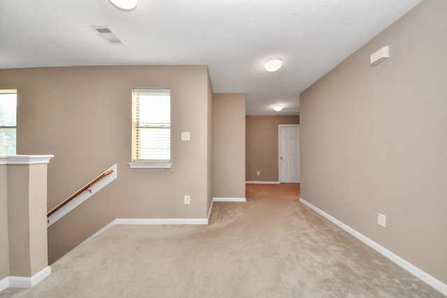 unfurnished room with light carpet