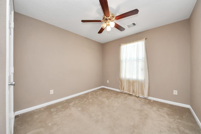 carpeted spare room with ceiling fan