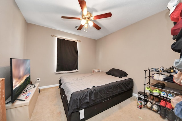 bedroom with light colored carpet and ceiling fan