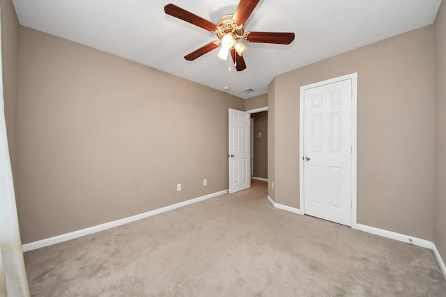 unfurnished bedroom with light colored carpet and ceiling fan