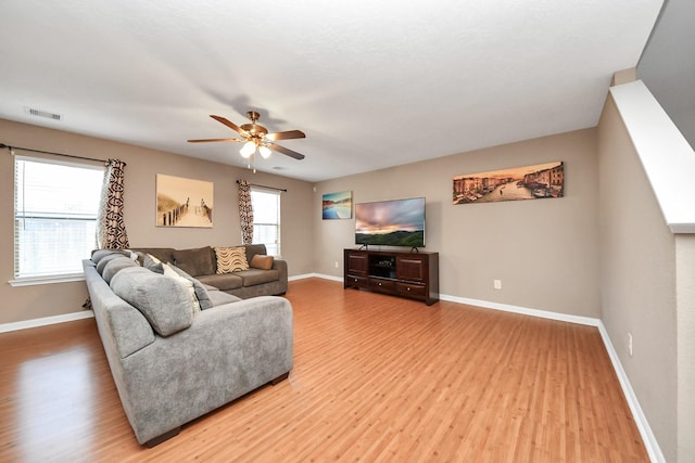 living room featuring hardwood / wood-style flooring and ceiling fan