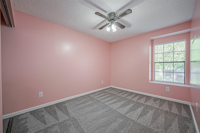 carpeted spare room featuring ceiling fan and a textured ceiling