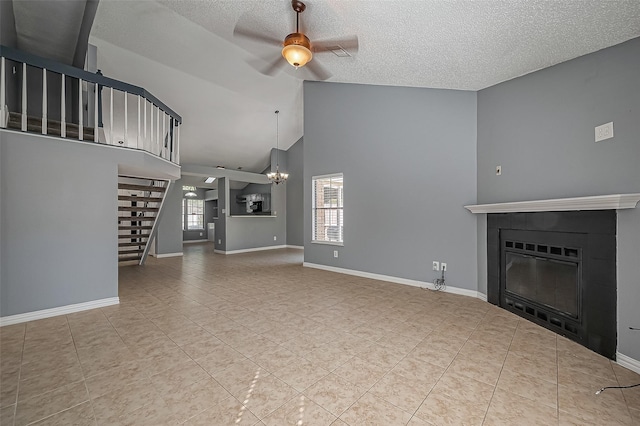 unfurnished living room with lofted ceiling, ceiling fan with notable chandelier, a textured ceiling, and light tile patterned floors