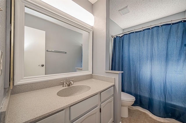 full bathroom with vanity, toilet, shower / bath combo, tile patterned floors, and a textured ceiling