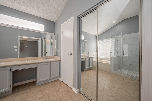 bathroom featuring lofted ceiling, tile patterned flooring, vanity, a textured ceiling, and shower with separate bathtub