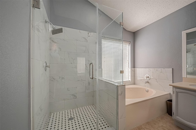 bathroom featuring vanity, shower with separate bathtub, and a textured ceiling