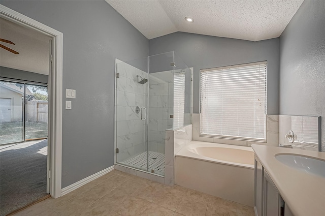 bathroom with lofted ceiling, tile patterned flooring, vanity, a textured ceiling, and separate shower and tub