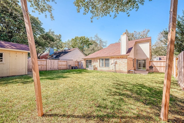 rear view of property with a storage shed and a lawn