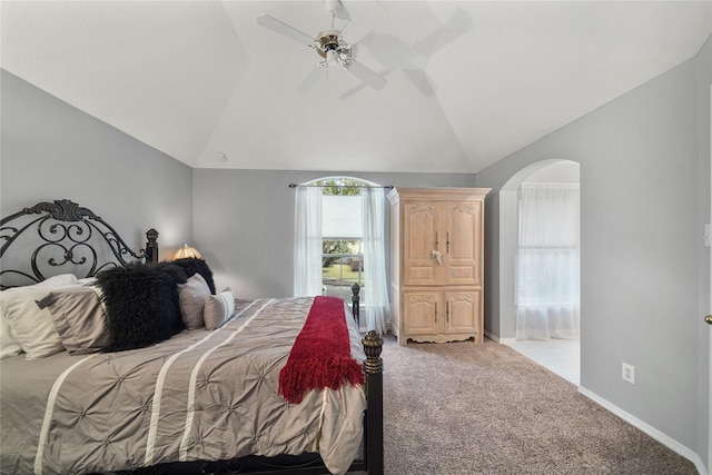 carpeted bedroom with ceiling fan and vaulted ceiling