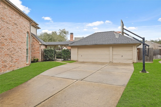 view of side of home with a garage and a lawn