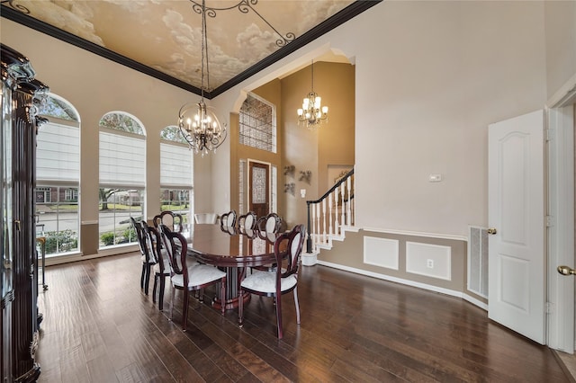 dining area featuring crown molding, dark hardwood / wood-style floors, and a notable chandelier