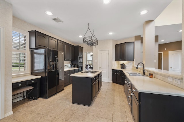 kitchen with sink, a center island, black appliances, light tile patterned flooring, and kitchen peninsula