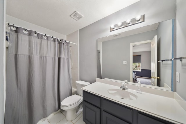 full bathroom with shower / tub combo with curtain, vanity, a textured ceiling, tile patterned floors, and toilet