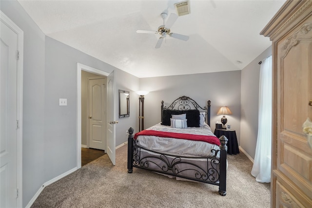 carpeted bedroom with vaulted ceiling and ceiling fan