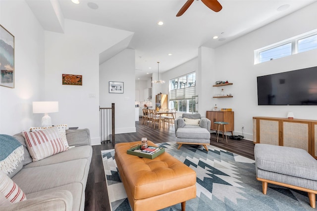 living room with ceiling fan and dark hardwood / wood-style flooring