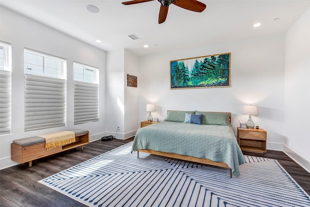 bedroom with dark hardwood / wood-style floors and ceiling fan