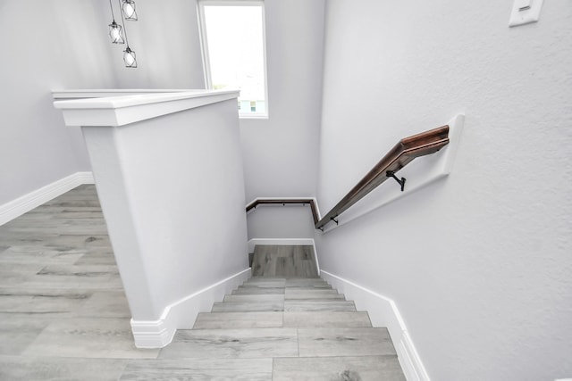 stairs featuring hardwood / wood-style floors