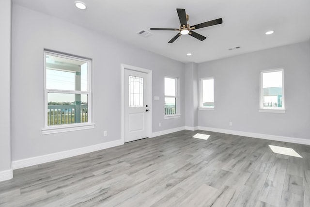 foyer with ceiling fan, light wood-type flooring, and a wealth of natural light