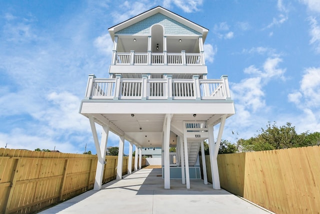 view of front of property featuring a carport and a balcony